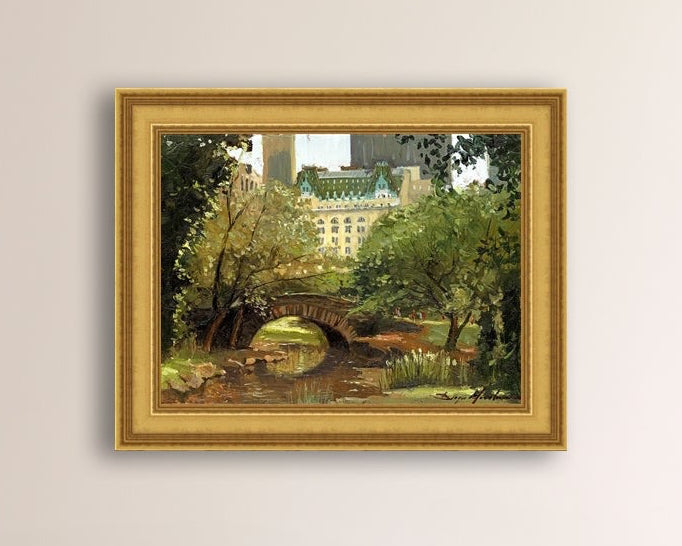 A canvas print of 'Summer in Central Park, New York' featuring bridge in the park and Plaza Hotel in the background.