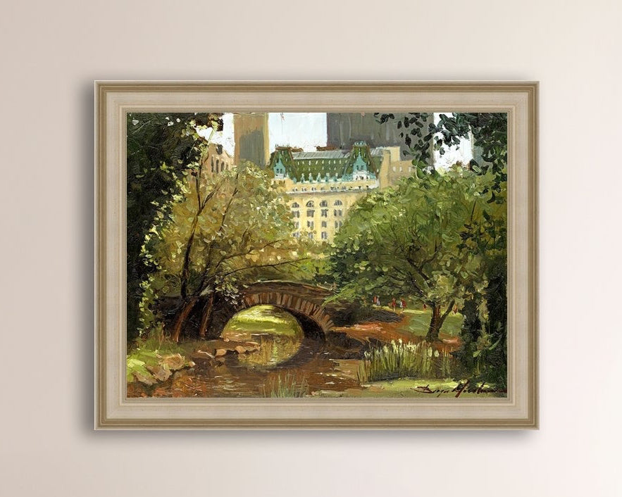 A canvas print of 'Summer in Central Park, New York' featuring bridge in the park and Plaza Hotel in the background.