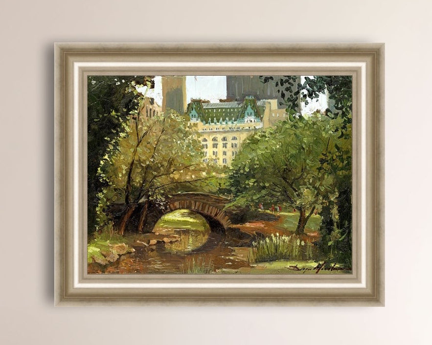 A canvas print of 'Summer in Central Park, New York' featuring bridge in the park and Plaza Hotel in the background.