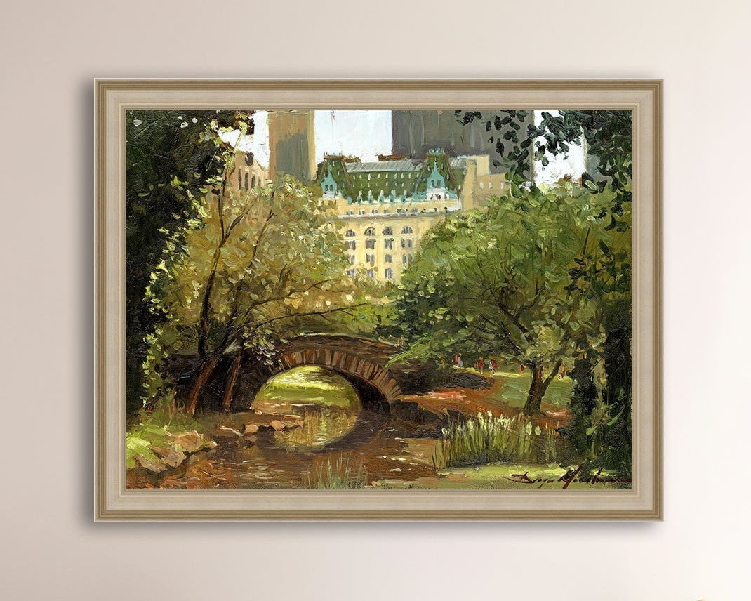 A canvas print of 'Summer in Central Park, New York' featuring bridge in the park and Plaza Hotel in the background.