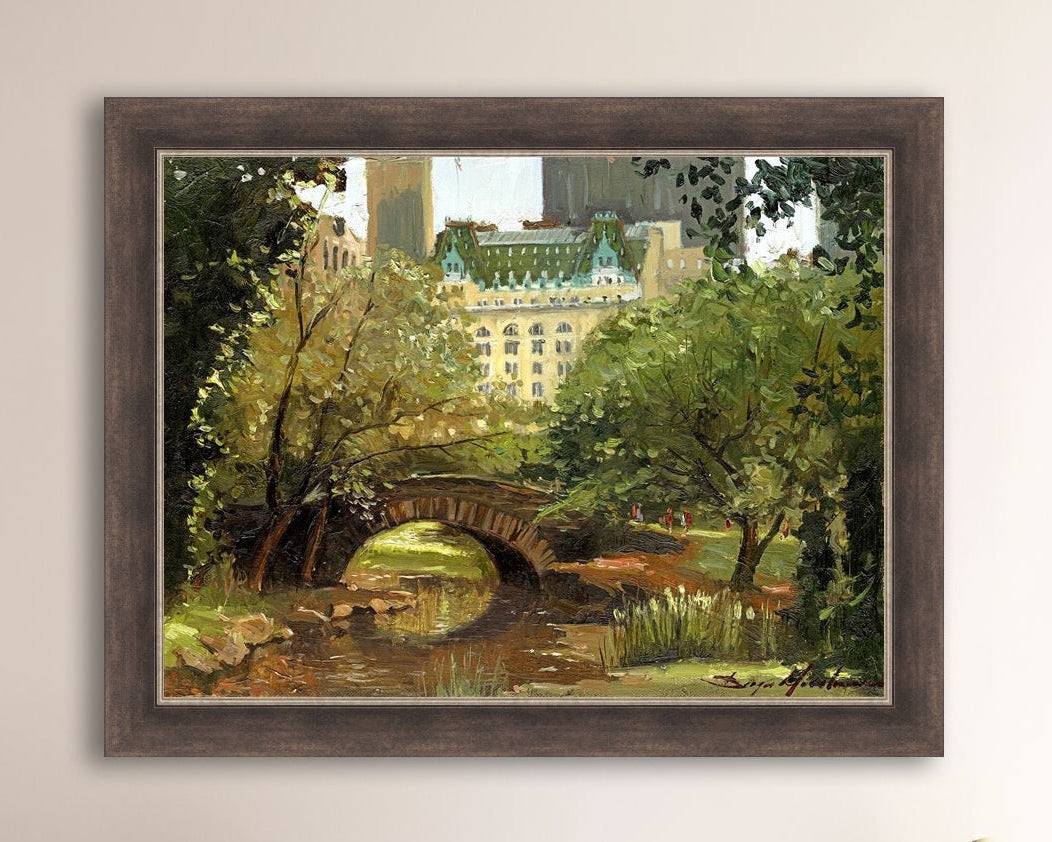 A canvas print of 'Summer in Central Park, New York' featuring bridge in the park and Plaza Hotel in the background.