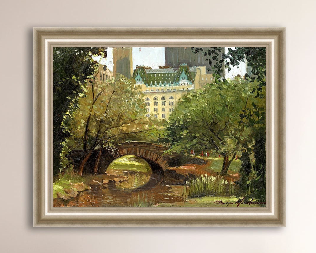 A canvas print of 'Summer in Central Park, New York' featuring bridge in the park and Plaza Hotel in the background.