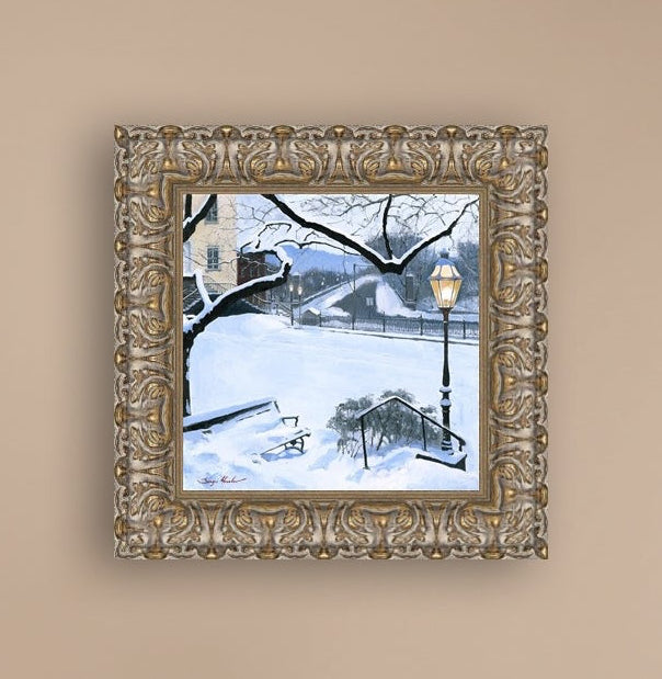 A canvas print featuring a snowy landscape with a bench, a lamp post, in the foreground, and Moravian Church in the background.