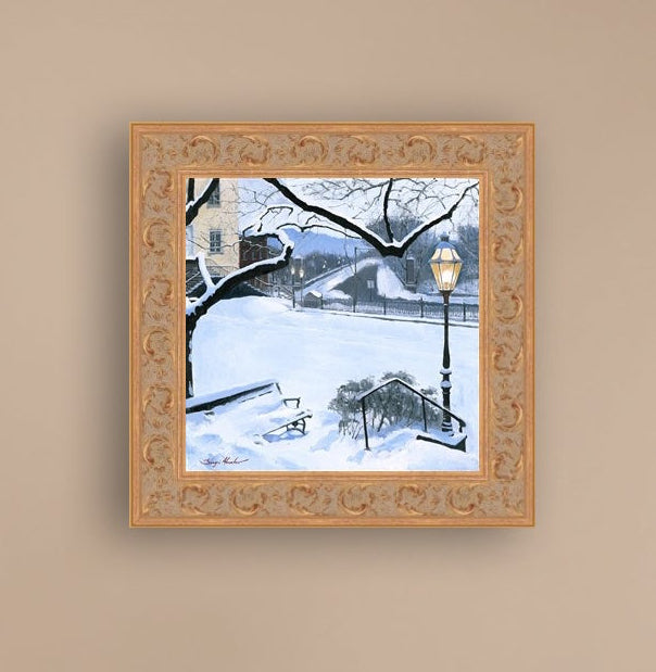 A canvas print featuring a snowy landscape with a bench, a lamp post, in the foreground, and Moravian Church in the background.