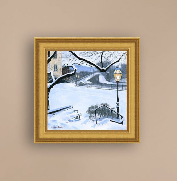 A canvas print featuring a snowy landscape with a bench, a lamp post, in the foreground, and Moravian Church in the background.
