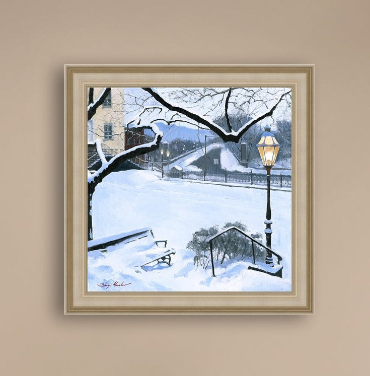 A canvas print featuring a snowy landscape with a bench, a lamp post, in the foreground, and Moravian Church in the background.