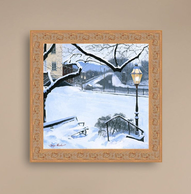 A canvas print featuring a snowy landscape with a bench, a lamp post, in the foreground, and Moravian Church in the background.