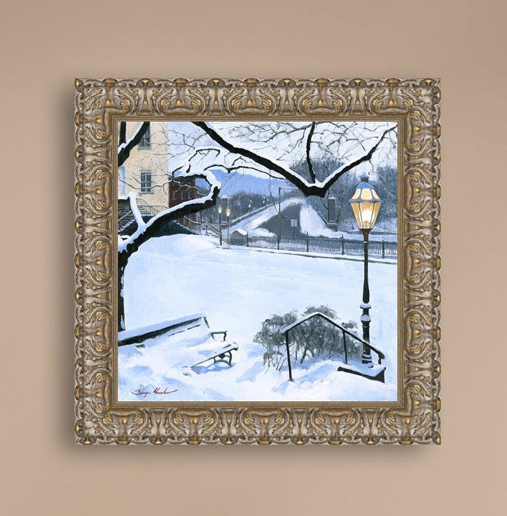 A canvas print featuring a snowy landscape with a bench, a lamp post, in the foreground, and Moravian Church in the background.