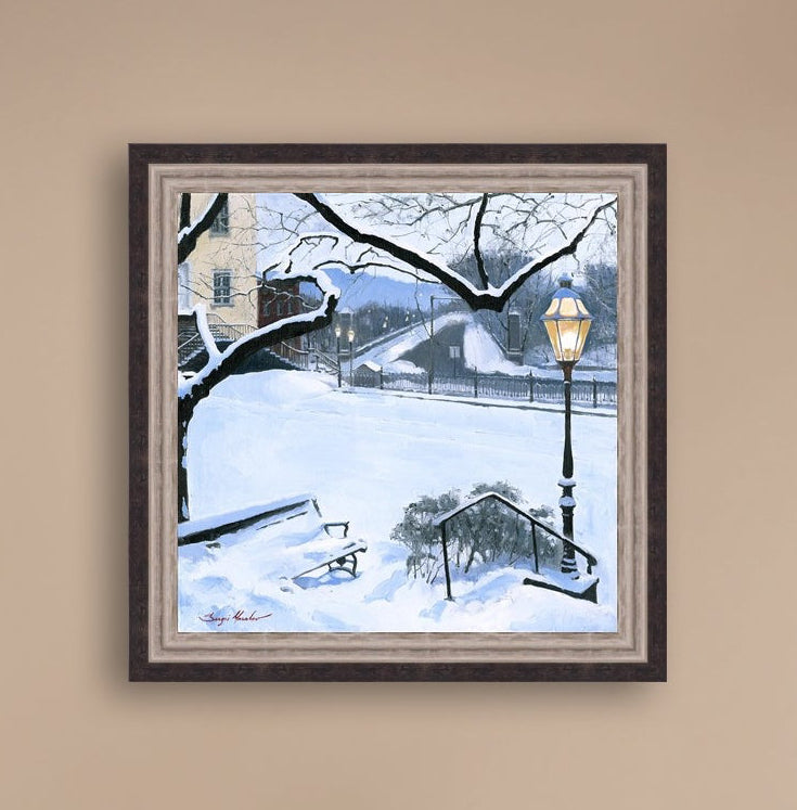 A canvas print featuring a snowy landscape with a bench, a lamp post, in the foreground, and Moravian Church in the background.