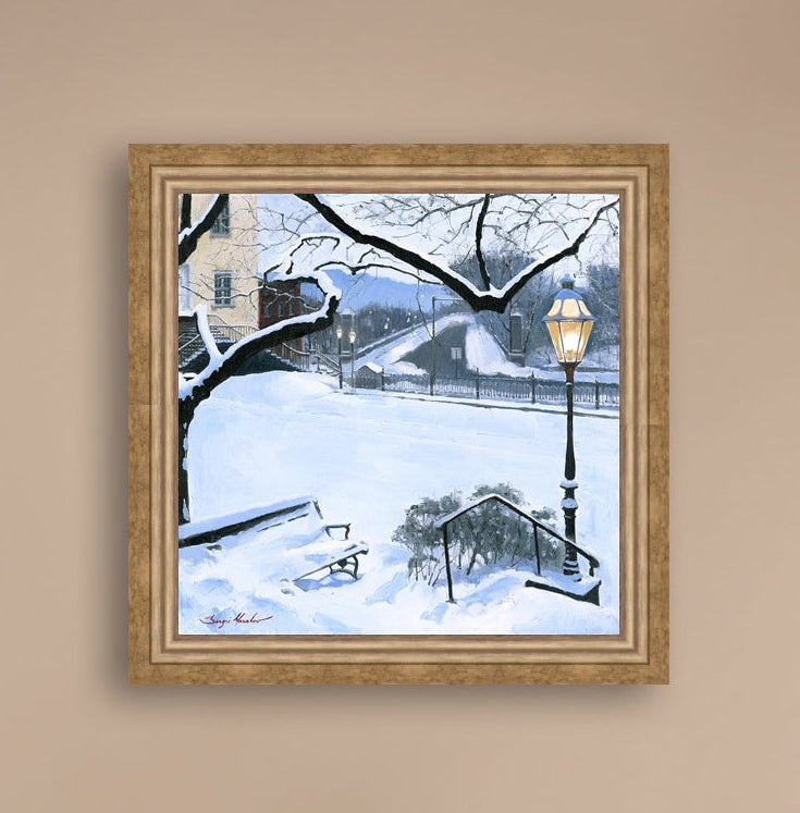 A canvas print featuring a snowy landscape with a bench, a lamp post, in the foreground, and Moravian Church in the background.