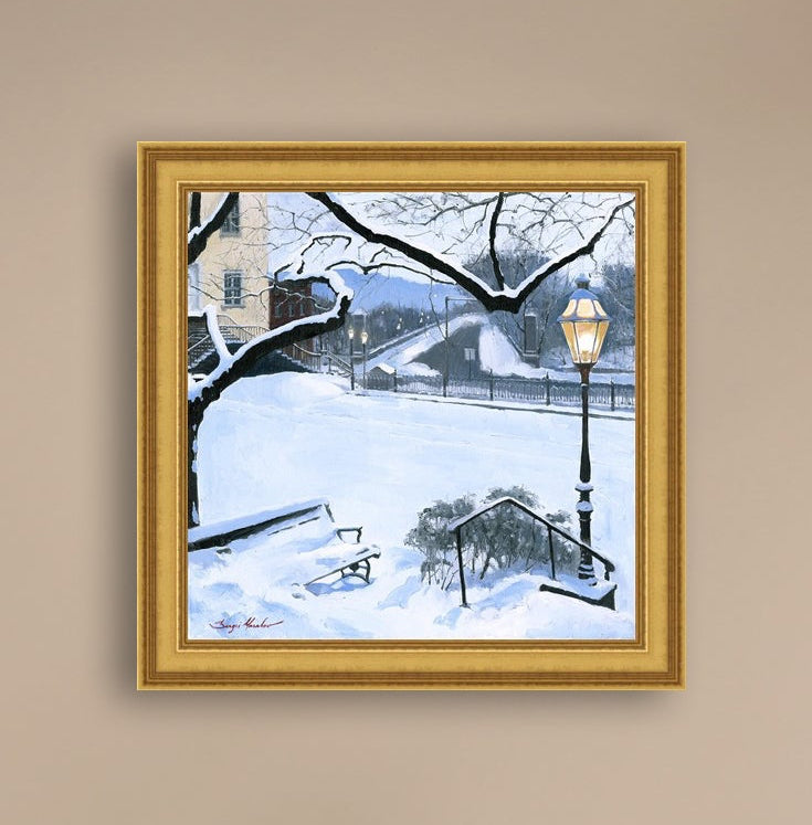 A canvas print featuring a snowy landscape with a bench, a lamp post, in the foreground, and Moravian Church in the background.