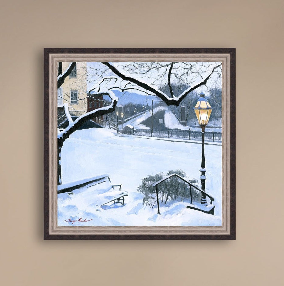 A canvas print featuring a snowy landscape with a bench, a lamp post, in the foreground, and Moravian Church in the background.