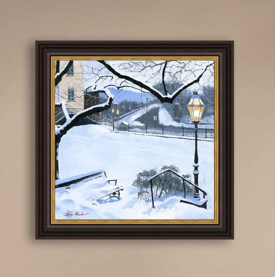 A canvas print featuring a snowy landscape with a bench, a lamp post, in the foreground, and Moravian Church in the background.