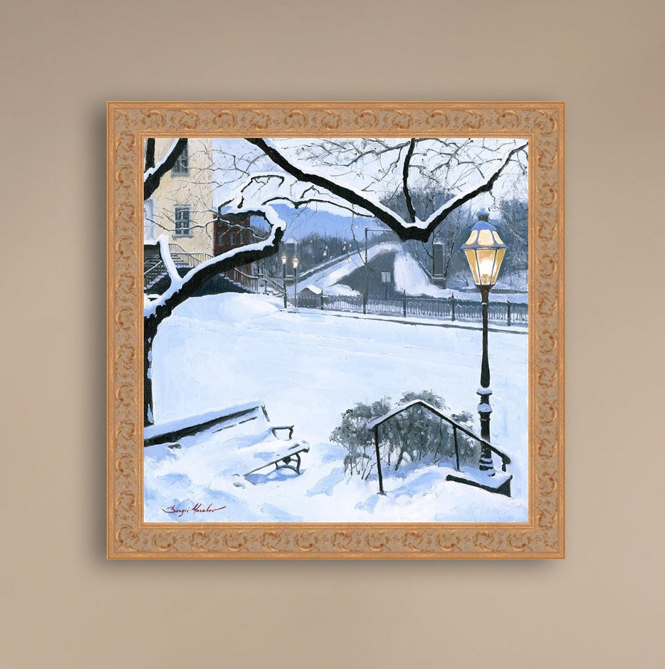 A canvas print featuring a snowy landscape with a bench, a lamp post, in the foreground, and Moravian Church in the background.