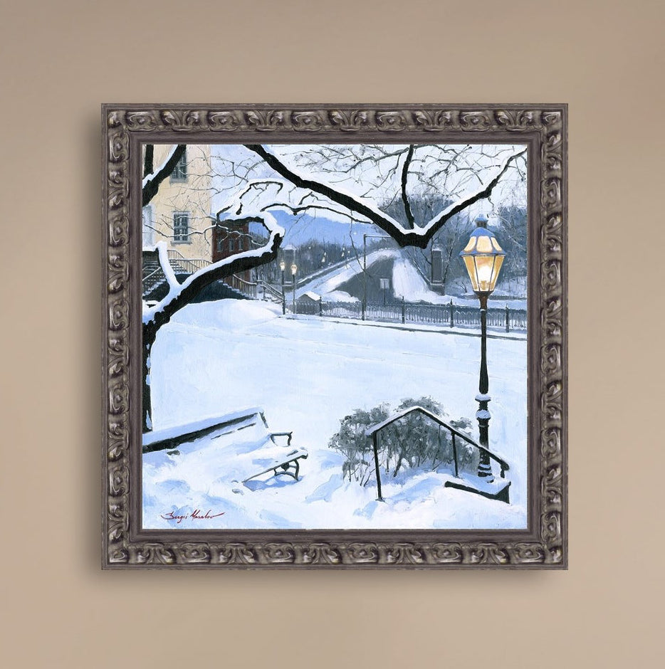 A canvas print featuring a snowy landscape with a bench, a lamp post, in the foreground, and Moravian Church in the background.