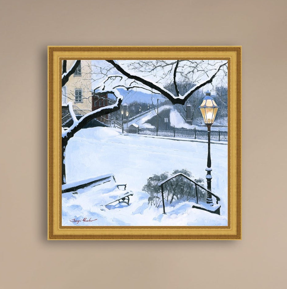 A canvas print featuring a snowy landscape with a bench, a lamp post, in the foreground, and Moravian Church in the background.