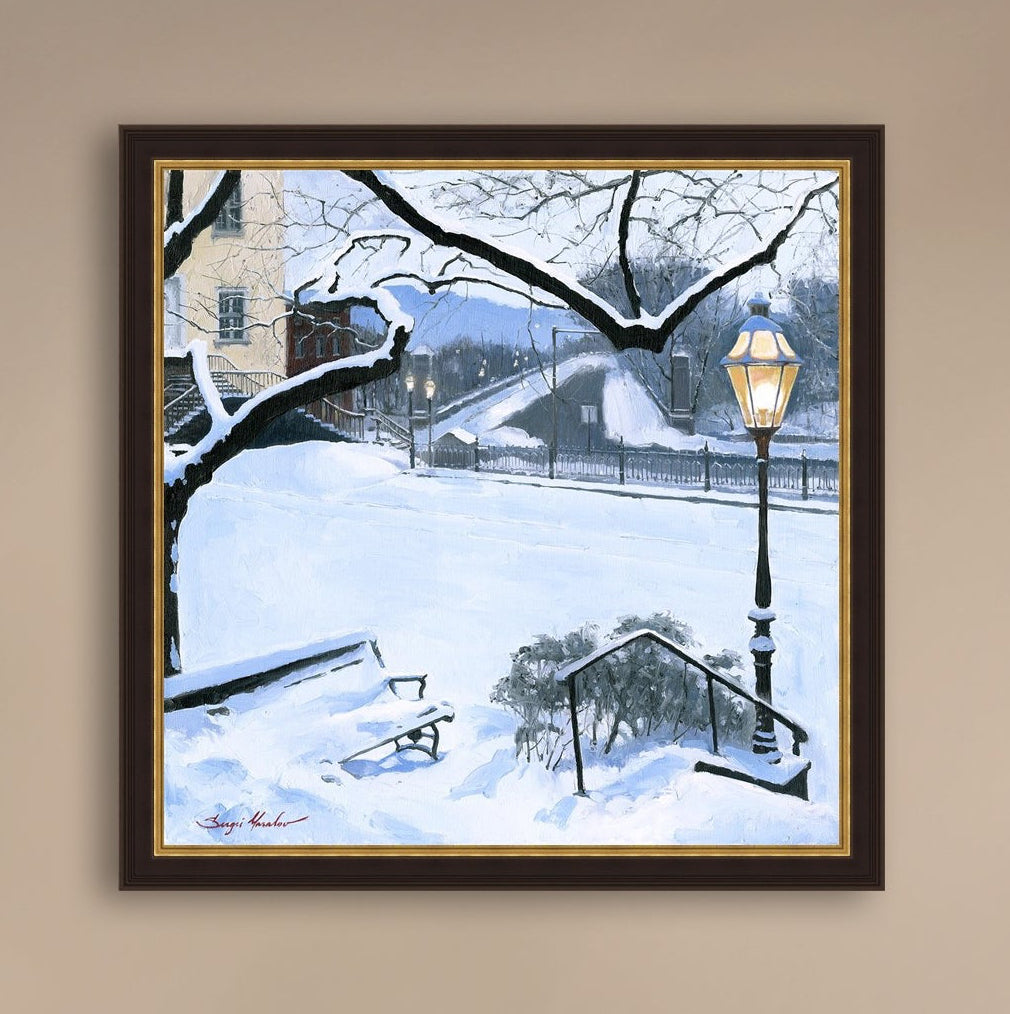 A canvas print featuring a snowy landscape with a bench, a lamp post, in the foreground, and Moravian Church in the background.