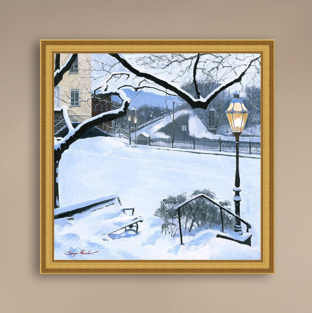 A canvas print featuring a snowy landscape with a bench, a lamp post, in the foreground, and Moravian Church in the background.