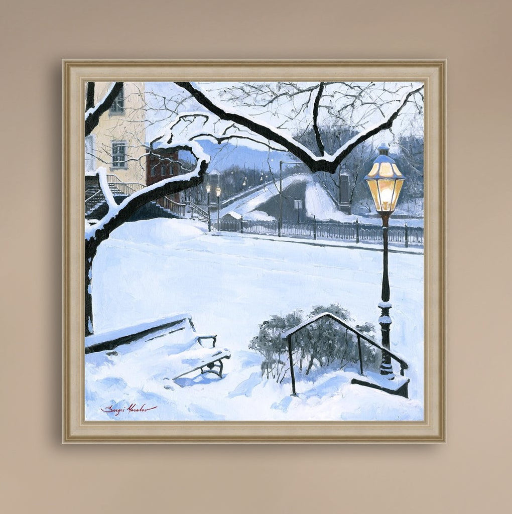 A canvas print featuring a snowy landscape with a bench, a lamp post, in the foreground, and Moravian Church in the background.