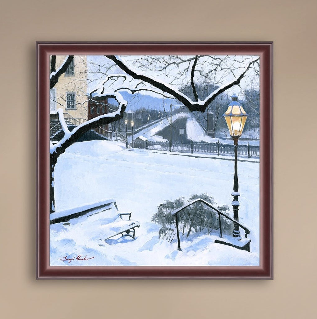 A canvas print featuring a snowy landscape with a bench, a lamp post, in the foreground, and Moravian Church in the background.