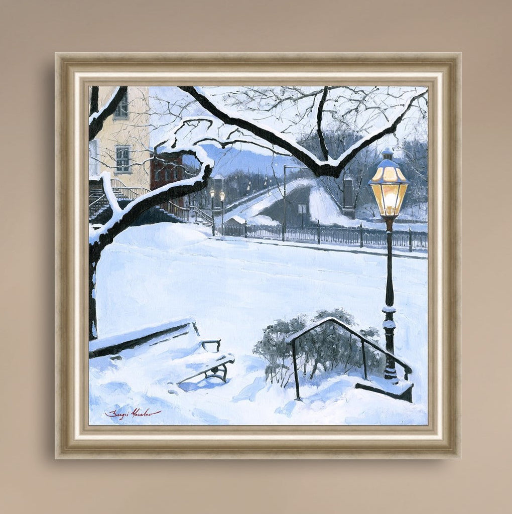 A canvas print featuring a snowy landscape with a bench, a lamp post, in the foreground, and Moravian Church in the background.