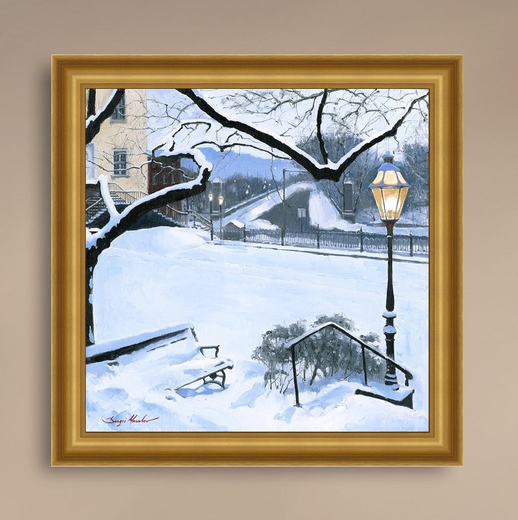 A canvas print featuring a snowy landscape with a bench, a lamp post, in the foreground, and Moravian Church in the background.