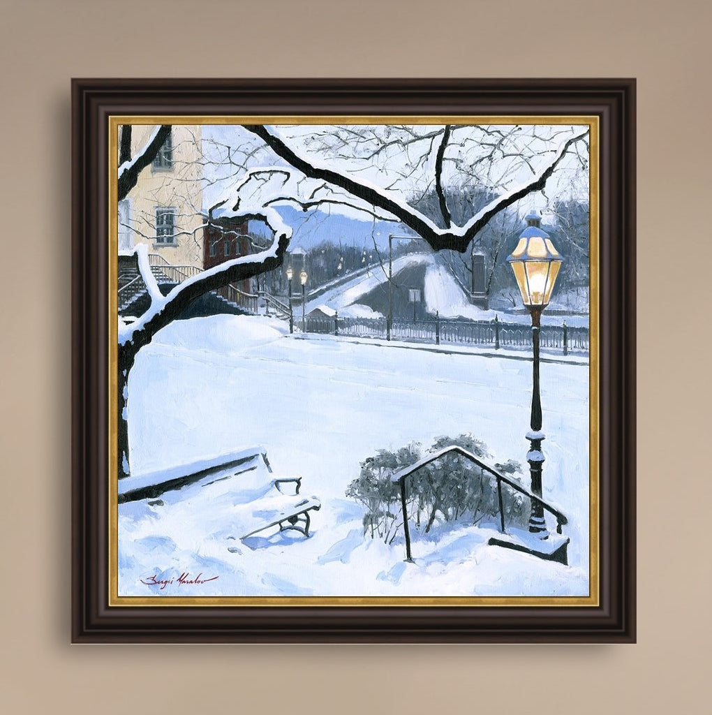 A canvas print featuring a snowy landscape with a bench, a lamp post, in the foreground, and Moravian Church in the background.