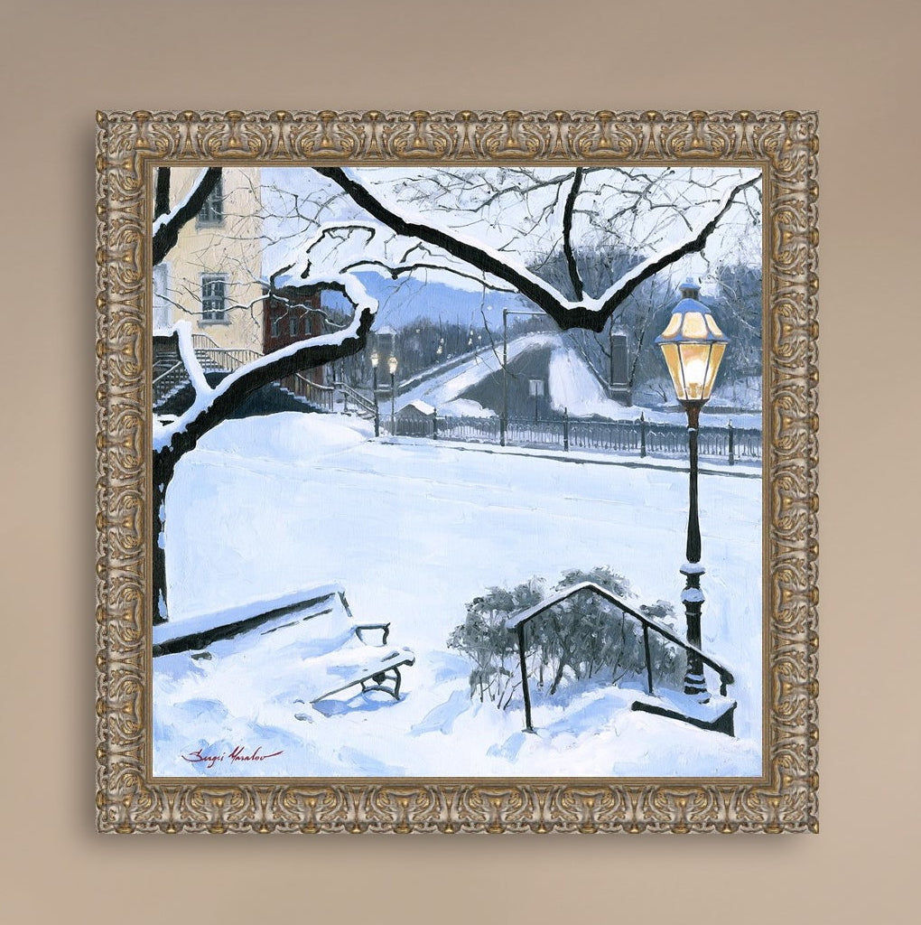 A canvas print featuring a snowy landscape with a bench, a lamp post, in the foreground, and Moravian Church in the background.