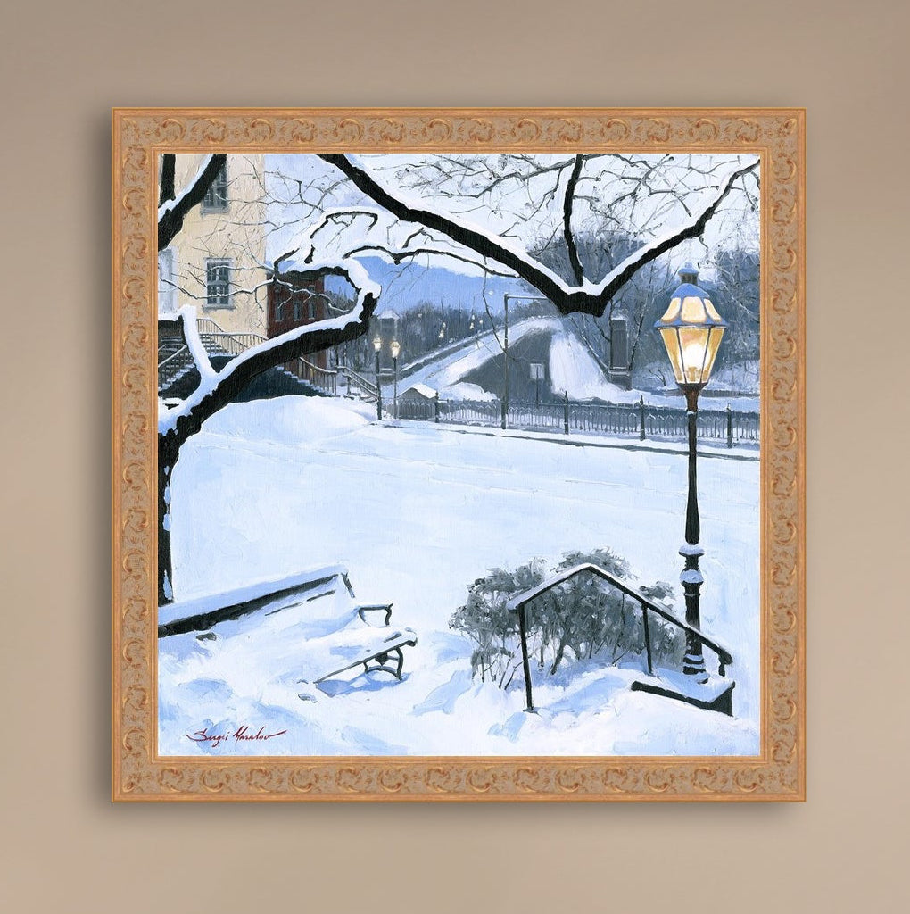 A canvas print featuring a snowy landscape with a bench, a lamp post, in the foreground, and Moravian Church in the background.