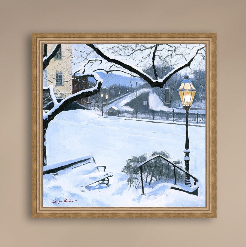 A canvas print featuring a snowy landscape with a bench, a lamp post, in the foreground, and Moravian Church in the background.