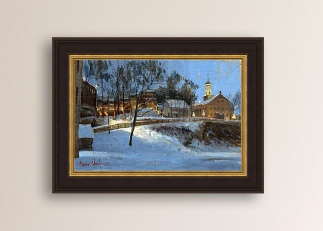 Winter scene with Moravian Church and Main Street, illuminated by lights.