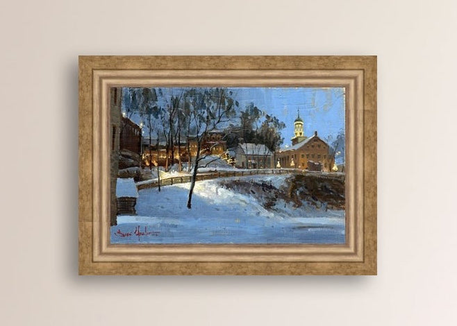 Winter scene with Moravian Church and Main Street, illuminated by lights.