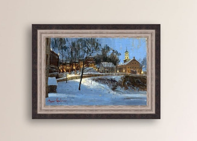 Winter scene with Moravian Church and Main Street, illuminated by lights.