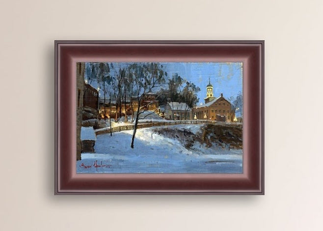 Winter scene with Moravian Church and Main Street, illuminated by lights.