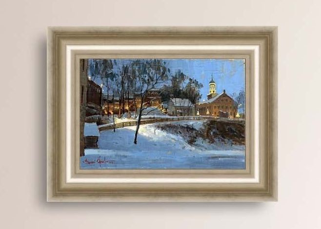 Winter scene with Moravian Church and Main Street, illuminated by lights.