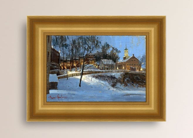 Winter scene with Moravian Church and Main Street, illuminated by lights.