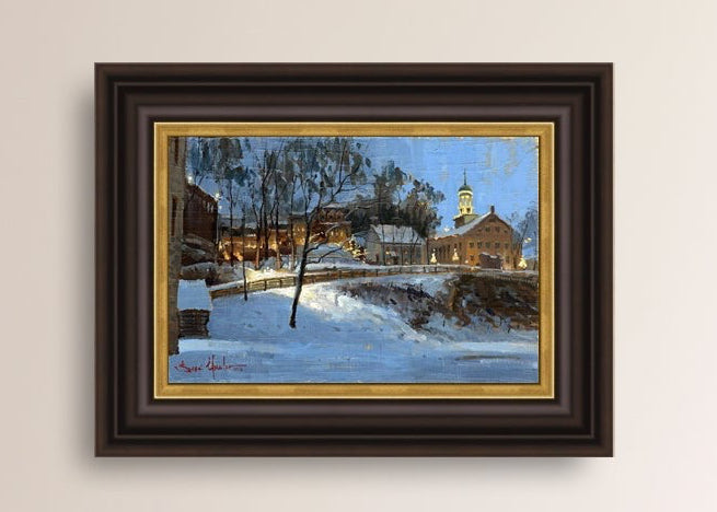 Winter scene with Moravian Church and Main Street, illuminated by lights.