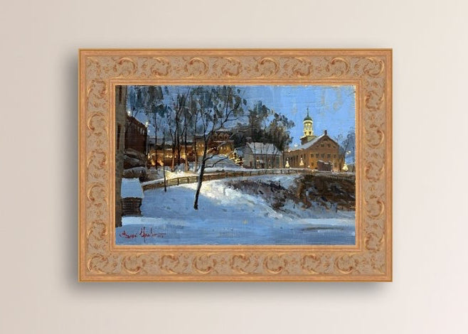 Winter scene with Moravian Church and Main Street, illuminated by lights.