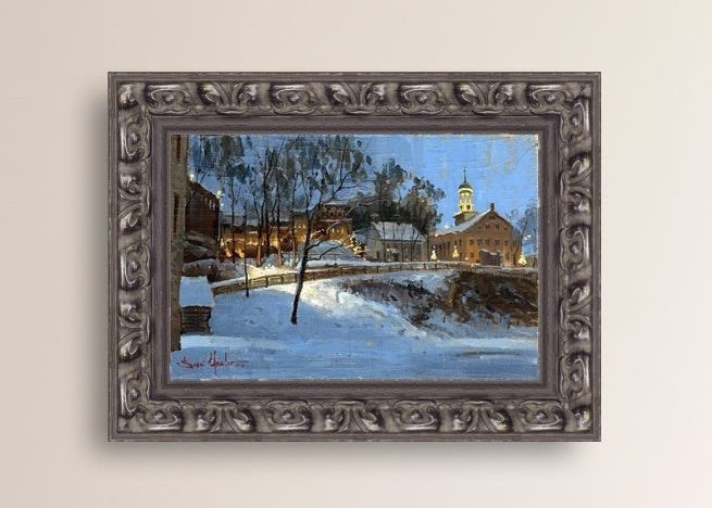 Winter scene with Moravian Church and Main Street, illuminated by lights.