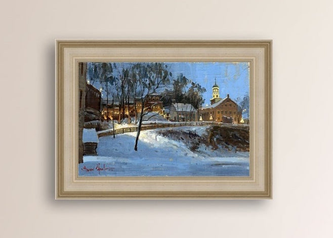 Winter scene with Moravian Church and Main Street, illuminated by lights.