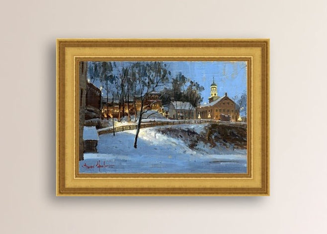 Winter scene with Moravian Church and Main Street, illuminated by lights.