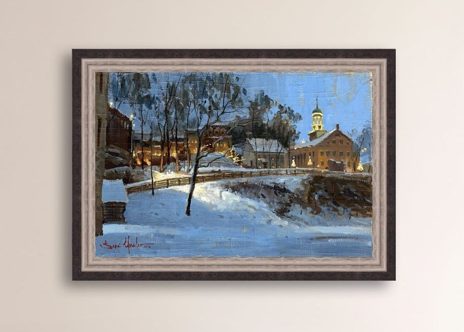 Winter scene with Moravian Church and Main Street, illuminated by lights.