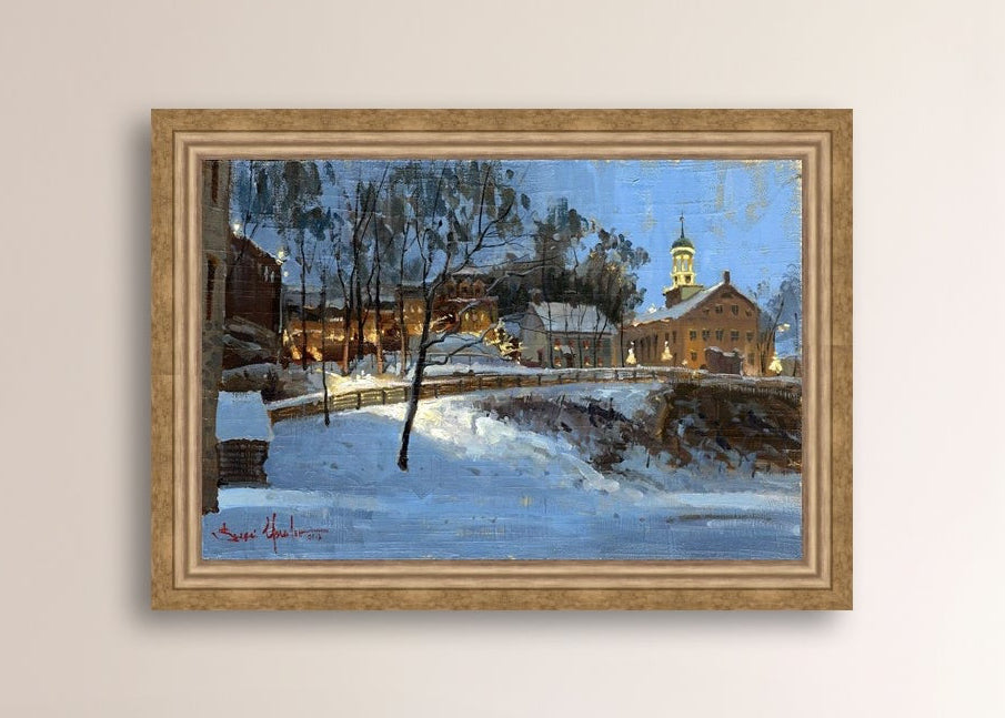 Winter scene with Moravian Church and Main Street, illuminated by lights.