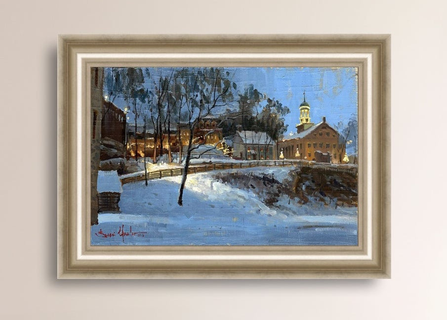 Winter scene with Moravian Church and Main Street, illuminated by lights.