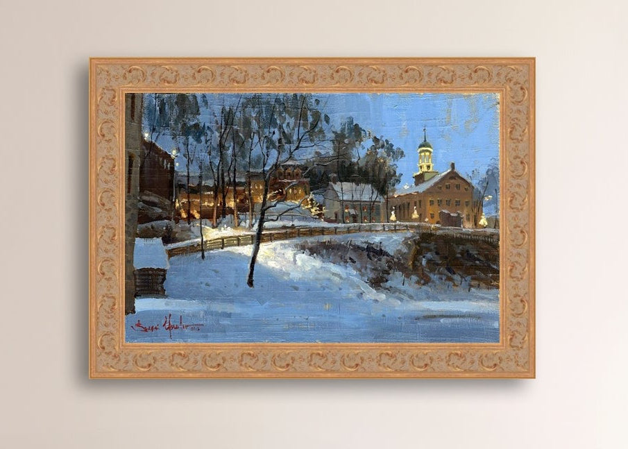 Winter scene with Moravian Church and Main Street, illuminated by lights.