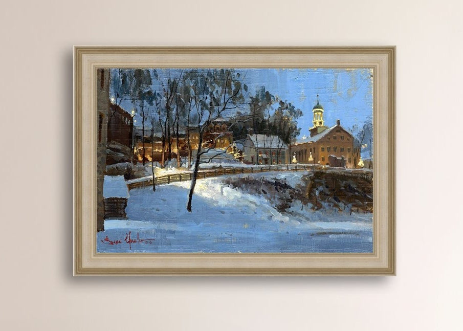 Winter scene with Moravian Church and Main Street, illuminated by lights.