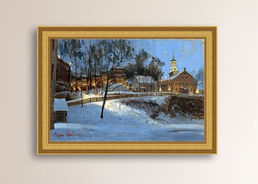 Winter scene with Moravian Church and Main Street, illuminated by lights.