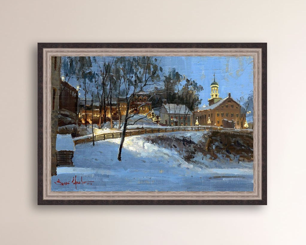 Winter scene with Moravian Church and Main Street, illuminated by lights.