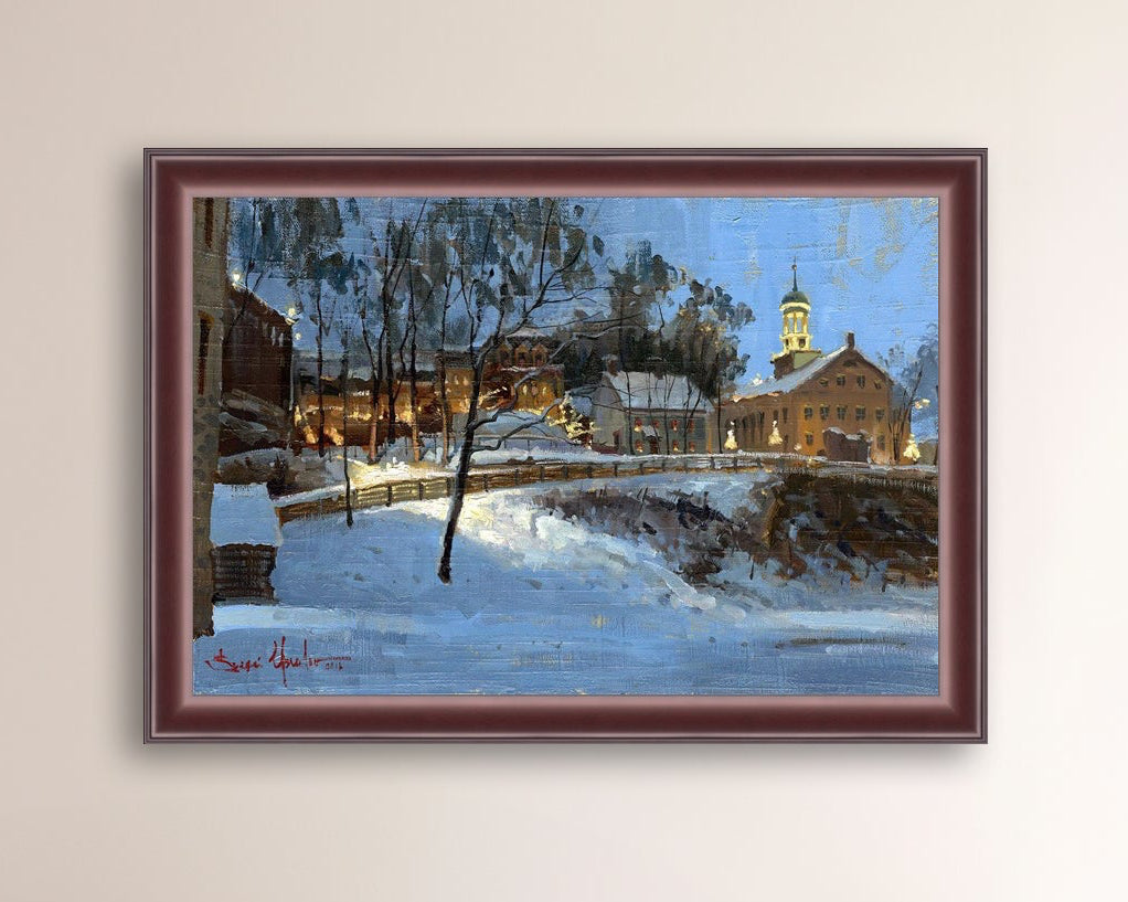 Winter scene with Moravian Church and Main Street, illuminated by lights.