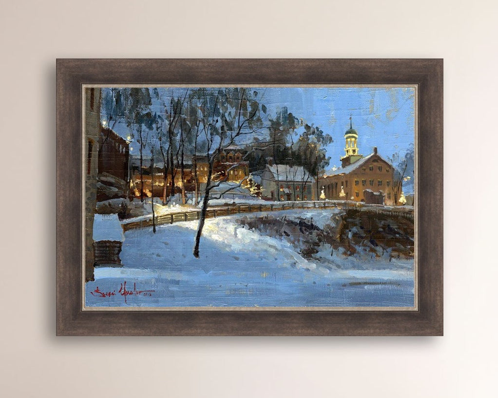 Winter scene with Moravian Church and Main Street, illuminated by lights.